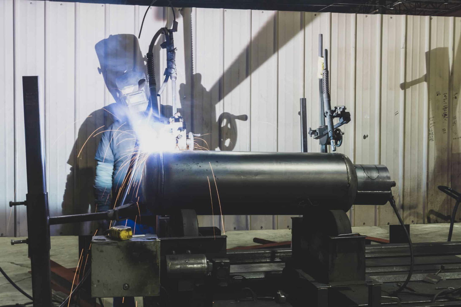 man welding large tank